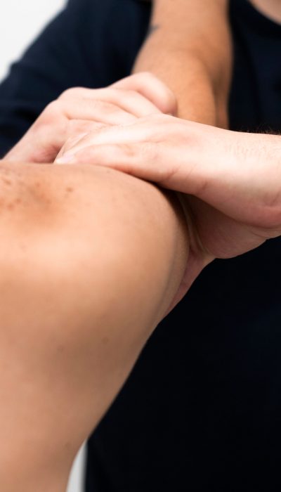 physiotherapist-massaging-man-s-arm